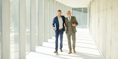 Two business men walking and talking