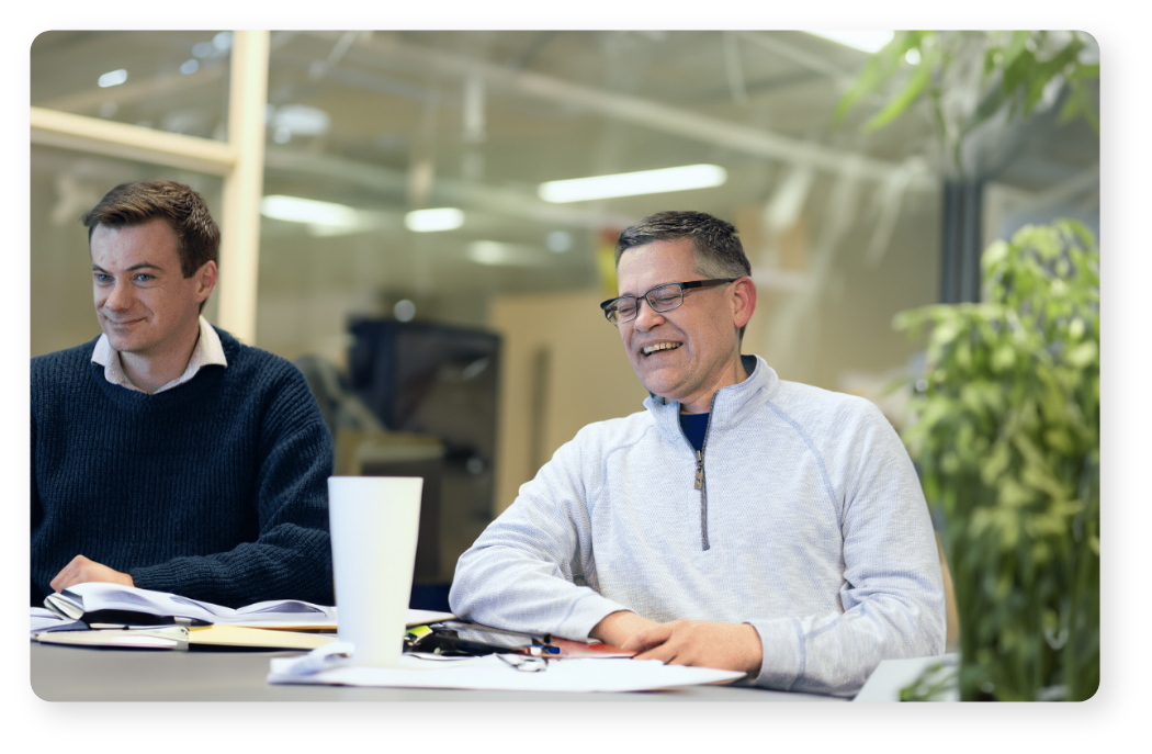 Two men laughing at a table